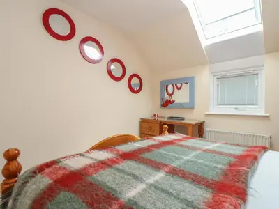 a bedroom with a bed and some plates on the wall at Kingsholm in Truro
