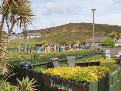 a garden with a park with a playground at Kingsholm in Truro