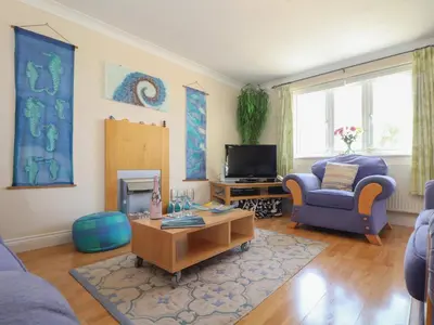 a living room with a couch and a table at Kingsholm in Truro
