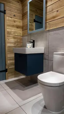 a bathroom with a white toilet and a sink at The Potting Barn in Saint Ervan