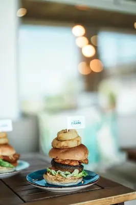 a stack of hamburgers on a plate on a table at The Potting Barn in Saint Ervan