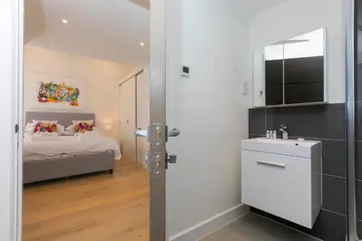 a bathroom with a bed and a sink in a room at Bay View in St Ives