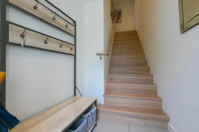 a staircase in a house with wooden floors at Bay View in St Ives