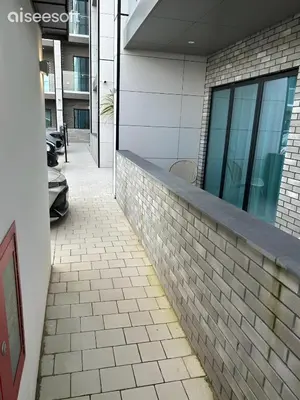 a brick wall next to a building at Beachside Apartment in Newquay