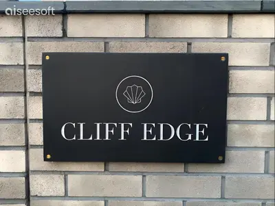 a sign on the side of a brick building at Beachside Apartment in Newquay