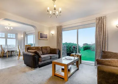 a living room with a couch and a table at Beacon Shepherd Huts in St. Agnes
