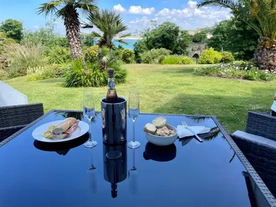 a table with a bottle of wine and a bowl of food at Millies in St Ives