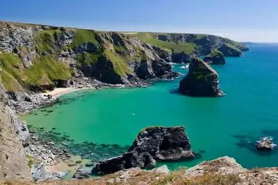 a view of a beach with rocks in the water at The Bright House, St Eval - near Padstow, Mawgan Porth, Watergate, Bedruthan & Porthcothan in Saint Ervan