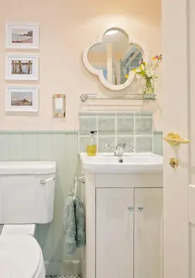 a bathroom with a white sink and a mirror at Enchanting Harbourside Cottage with Panoramic Views in Polruan