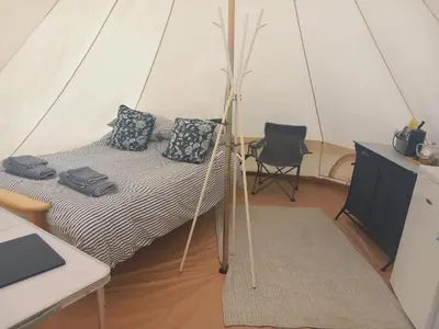 a bedroom with a bed in a tent at Hawk's View Bell Tent at Higher Hawksland Farm in Saint Issey