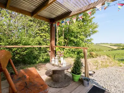 a wooden patio with a table and a chair at Shepherds Retreat in Launceston