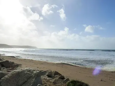 a sandy beach with the ocean in the background at Puddle Duck Shepherds Hut in Launceston