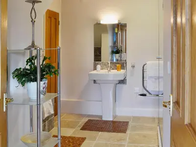 a bathroom with a sink and a mirror at The Coach House - 24439 in Bodmin