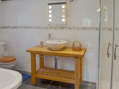 a bathroom with a sink and a toilet and a shower at Wallhouse Barn in Blisland