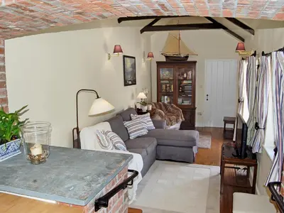 a living room with a couch and a table at Game Larder Cottage in Saint Mabyn