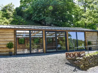 a glass house with a roof on top of it at The Old Chapel in Washaway