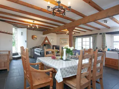 a kitchen and dining room with a table and chairs at The Roundhouse - Tbe in Crackington Haven