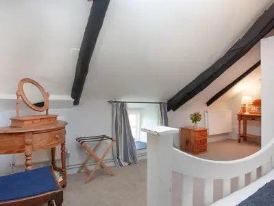 a attic room with a desk and a mirror at The Annexe - Tbh in Crackington Haven