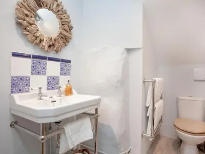 a bathroom with a sink and a toilet at The Annexe - Tbh in Crackington Haven
