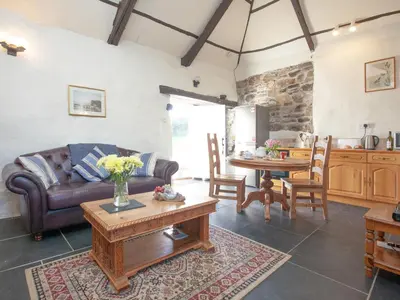 a living room with a couch and a table at The Annexe - Tbh in Crackington Haven