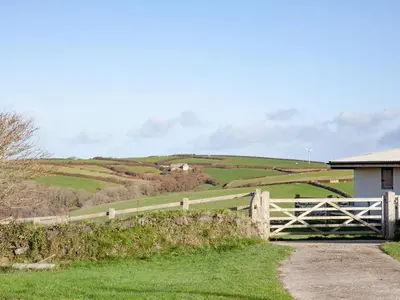 a white fence in the middle of a field at The Annexe - Tbh in Crackington Haven