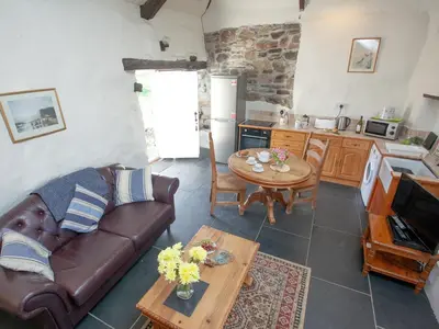 a living room with a couch and a table at The Annexe - Tbh in Crackington Haven