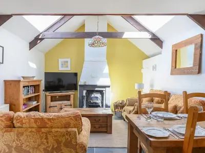 a living room with a couch and a table at Cross Cottage in Saint Breward