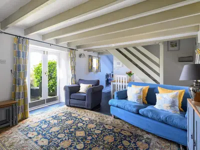 a blue couch and two chairs in a living room at High View in Saint Breward