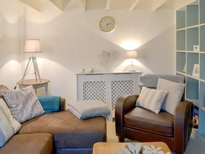 a living room with a couch and a chair at Gumburnville in Lanteglos