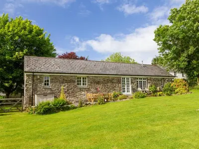 an old stone house with a large yard at Drovers in Lanteglos