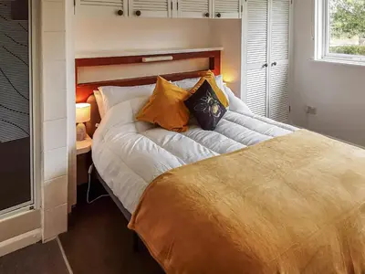 a large bed in a room with a bed sidx sidx sidx at Valley Truckle Bungalow in Camelford