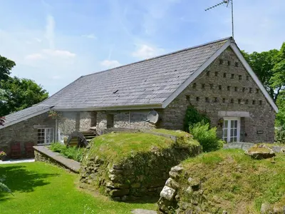 an old stone church with a roof at Dovecote-Tnq in Camelford