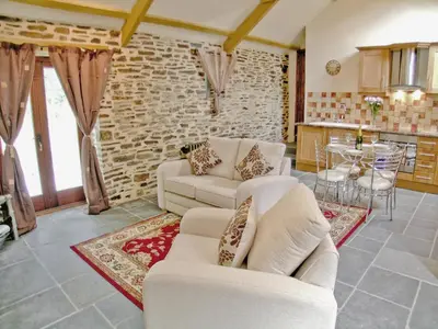 a living room with two white couches and a kitchen at Lower Shippen - 23493 in North Petherwin