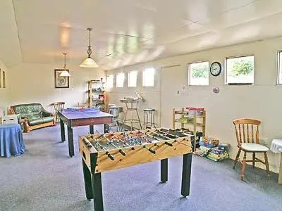 a large room with a table and chairs in it at Barfield's Cherry Tree Cottage in Warbstow