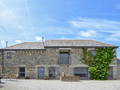 an old stone house with a ivy at Trescowthick Barn in Zelah
