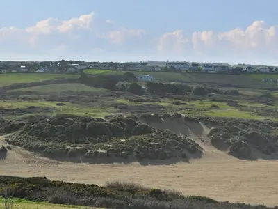 a view of a field with houses in the background at Willow Cottage in Newlyn East
