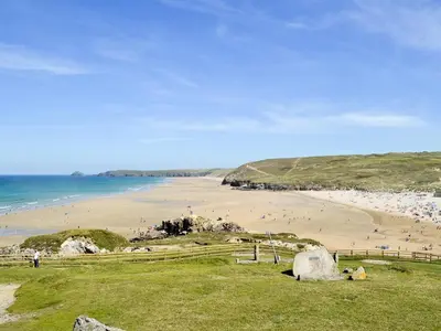 a beach with a bunch of people on the sand at Willow Cottage in Newlyn East
