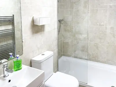 a bathroom with a toilet and a sink and a shower at Palm Villa in Saint Columb Minor