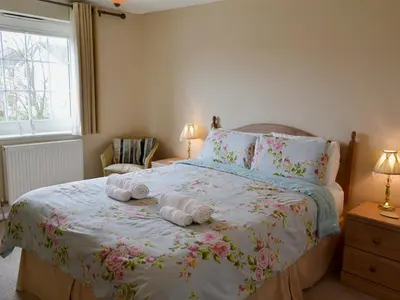 a bedroom with a bed with two towels on it at The Old Butchers in Crantock