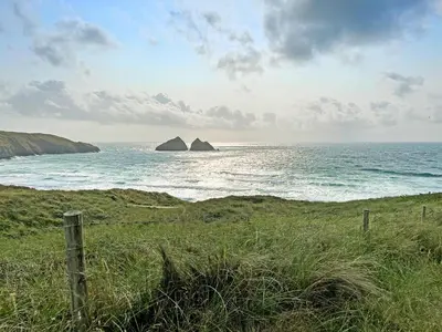 a view of the ocean with two rocks in the water at North Shore in Crantock