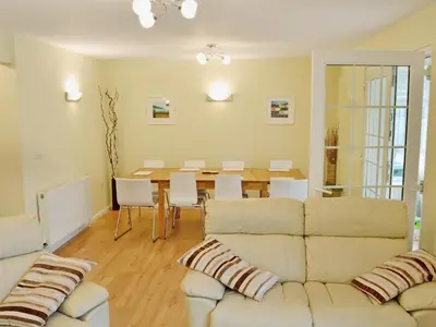 a living room with a couch and a table at North Shore in Crantock