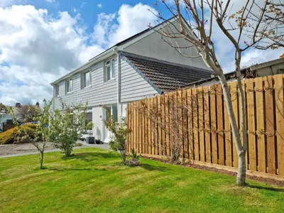a wooden fence in front of a house at Sweet Briar in Newquay