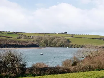 a small boat in a large river in a field at Sweet Briar in Newquay