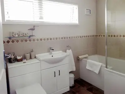 a bathroom with a sink and a toilet and a shower at Sweet Briar in Newquay