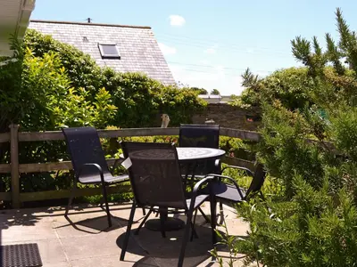 a table and chairs sitting on a patio at Treyarnon in St Merryn