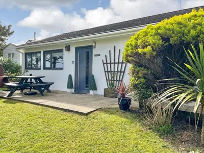 a house with a picnic table in the yard at Fistral in St Merryn