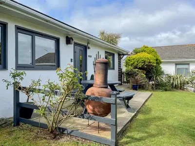 a large vase sitting outside of a house at Fistral in St Merryn