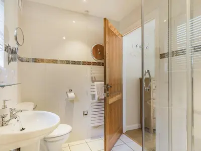 a bathroom with a toilet and a sink and a shower at Creekside in Little Petherick
