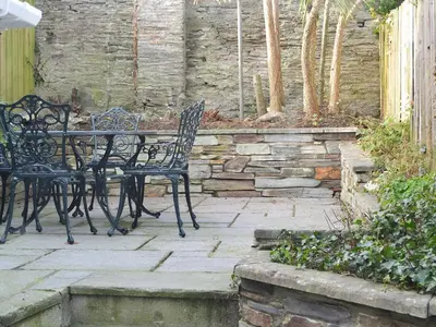 a table and chairs sitting on a stone patio at Sandpipers in Padstow