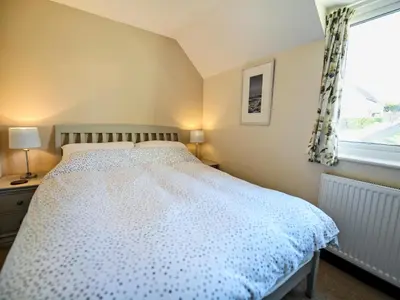 a bedroom with a bed and a window at The Yellow House in Padstow